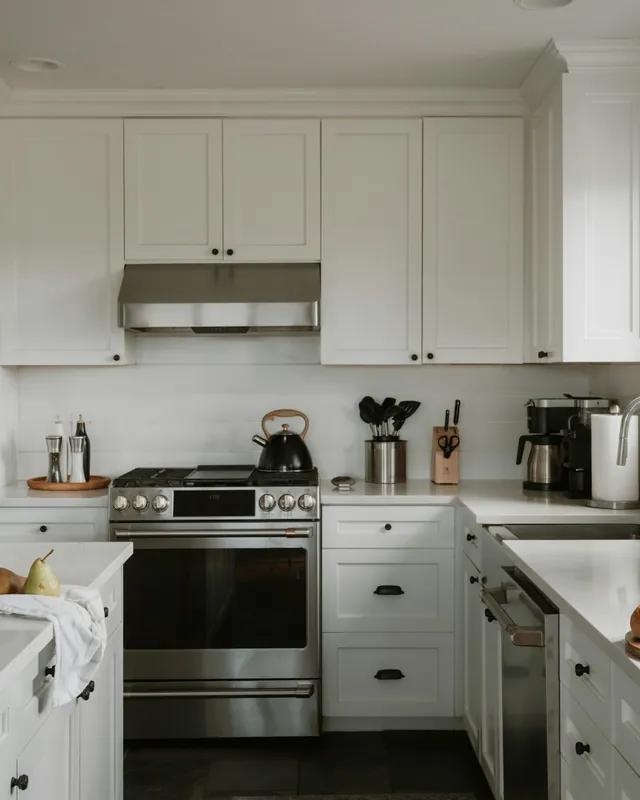 Bright remodeled kitchen with white cabinets and stone counters
